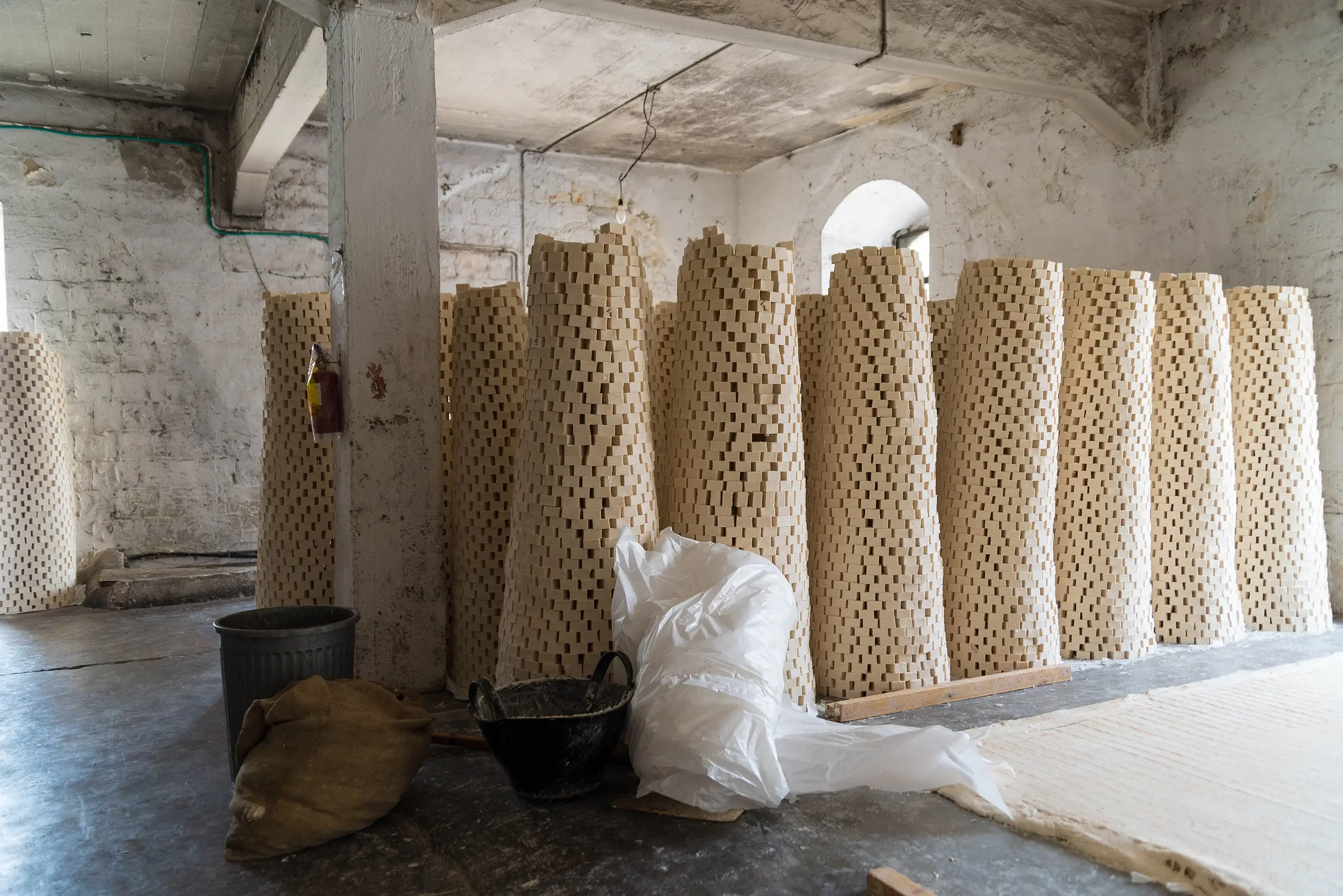 Bars of olive-oil soap stacked in drying towers in a workshop